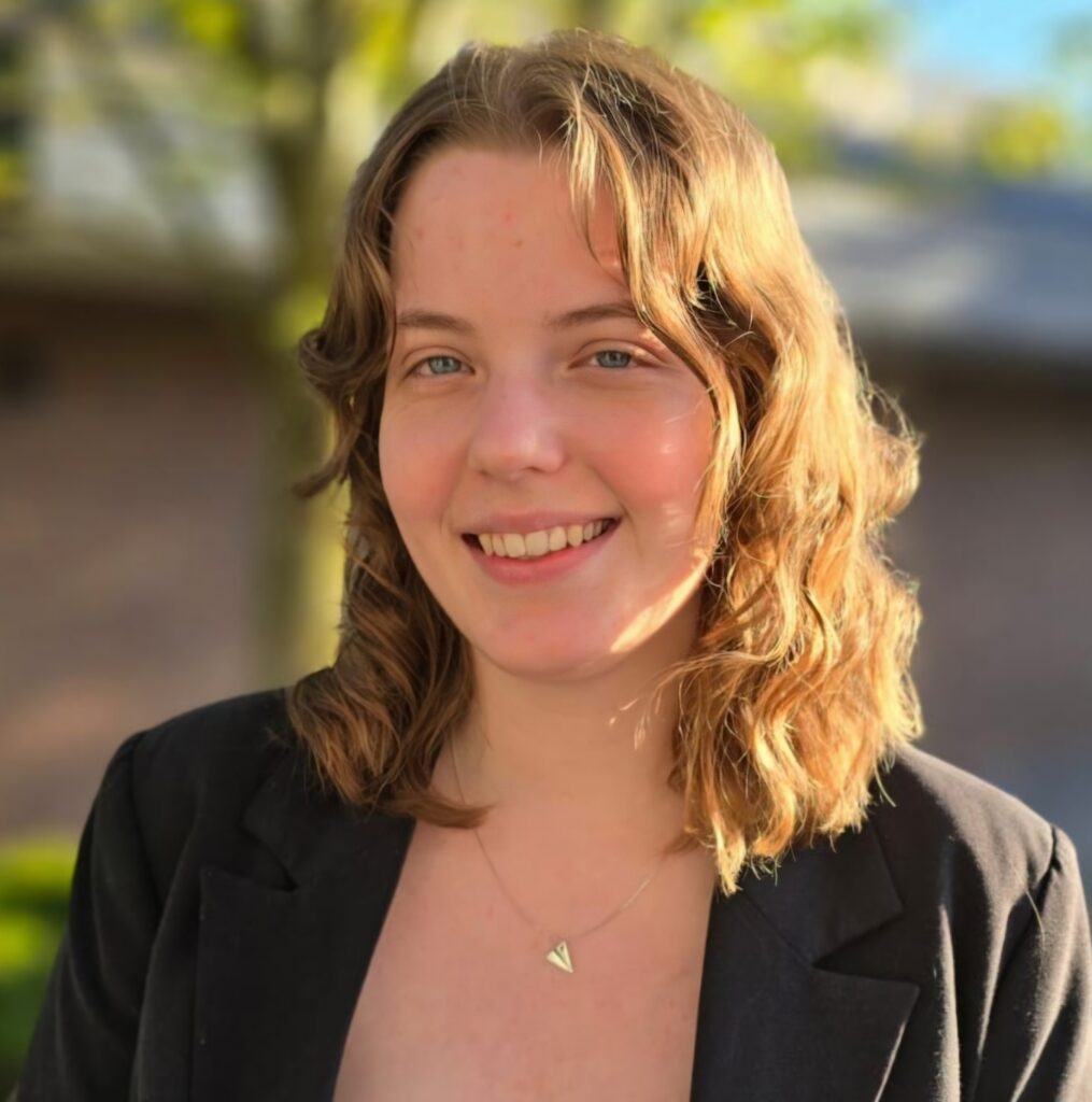 Judit Nagy is a Director at Large at the PABC Board. She is standing in front of a tree.