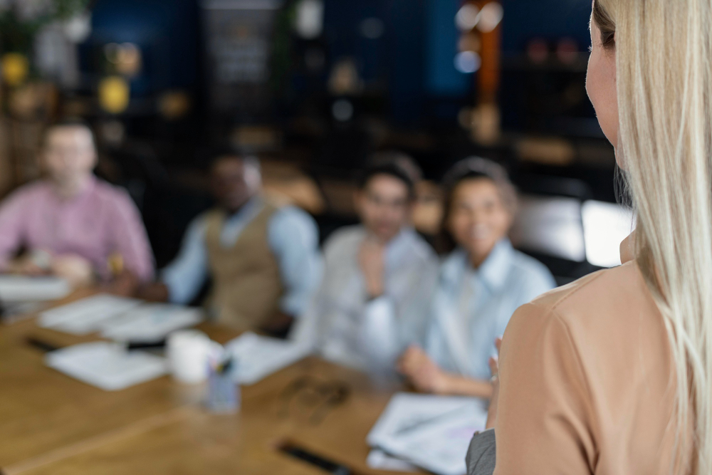 Woman presenting resources guide to board members